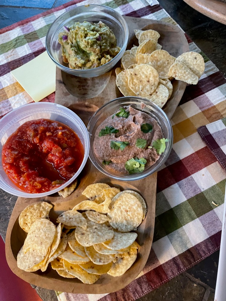 Chips and dips appetizer for Mexican party.