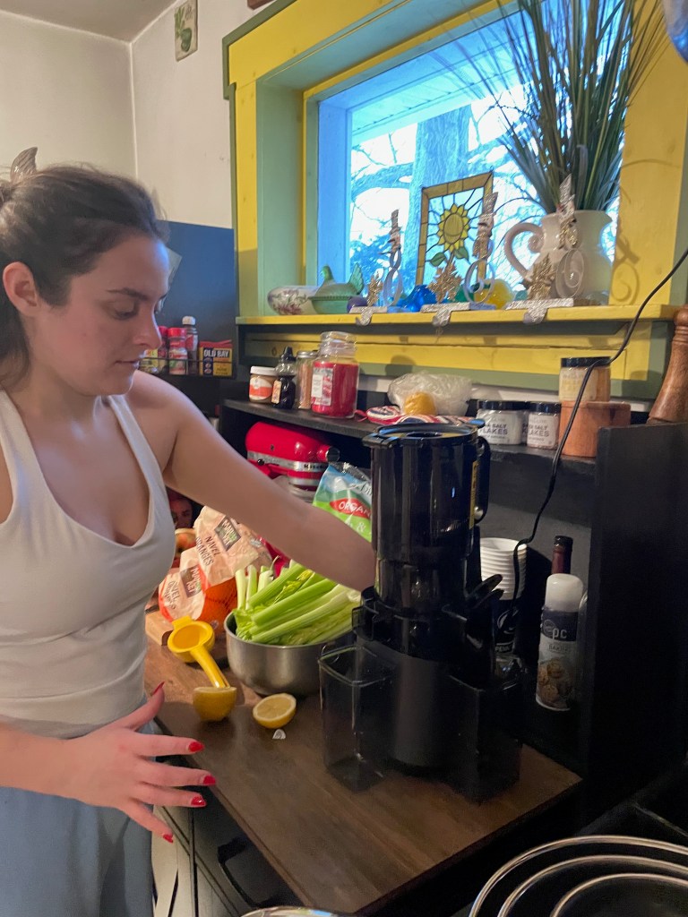 Daughter juicing greens